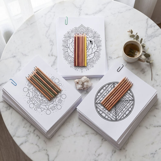 Trío Mente en Blanco, combo de mandalas Geométricos, Flores & Naturaleza e Hipnóticos para colorear, flat lay sobre mármol blanco con lápices, taza y cuarzo - Calma en Tinta